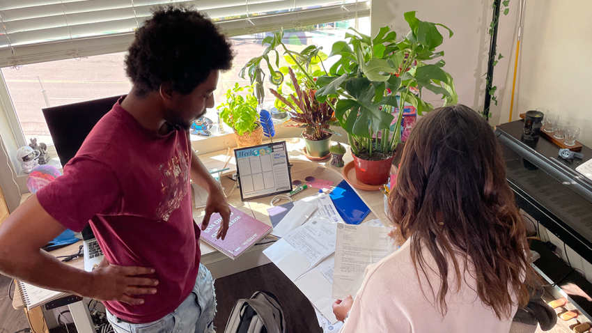 Navy veteran Sky Lowe (left) shows investigative reporter Alexis Rivas (right) paperwork from the VA that declared him deceased.